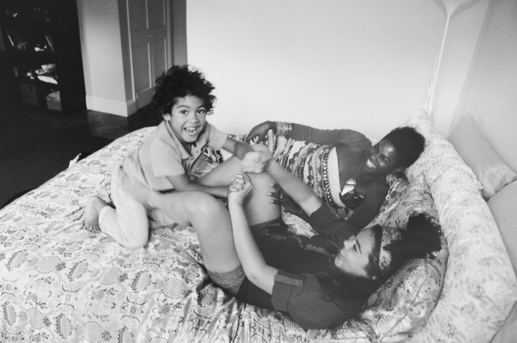 Black and white shot Trenesa Stanford-Danuser with her children in the bedroom