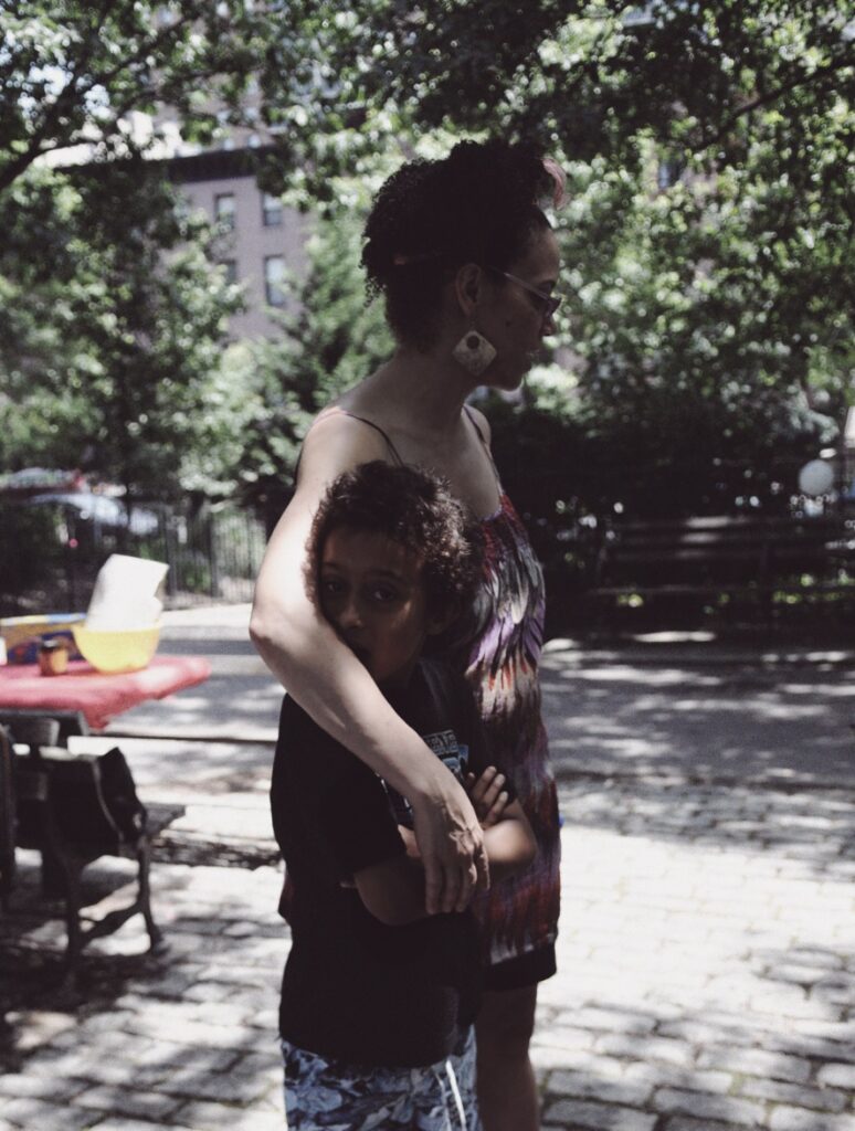 Coco Fusco holding her child