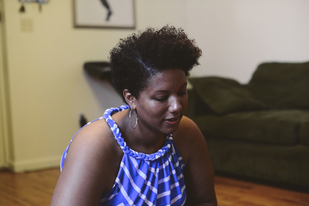 Black woman with short natural hair looking down