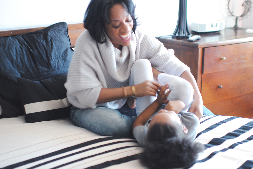 LaShann DeArcy Hall tickling her child