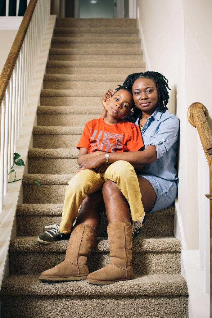 Agatha Achindu posing with her son on the stairs