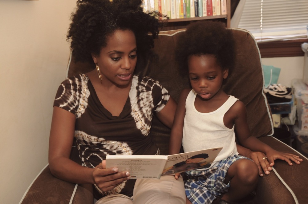 Rhonda Ross reading a book with her son