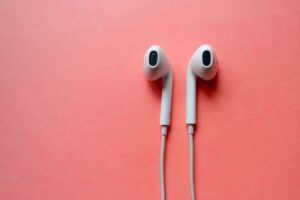Apple headphones on pink background