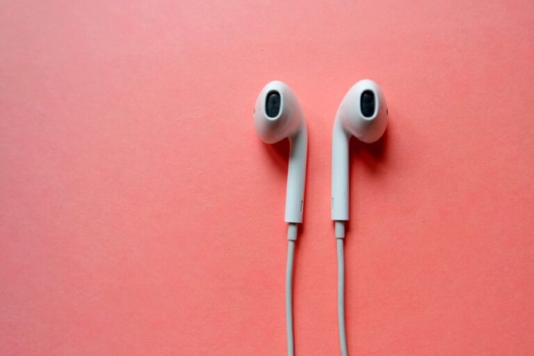 Apple headphones on pink background
