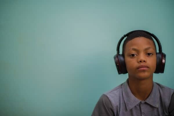 Tween Black boy wearing large noise-blocking headphones