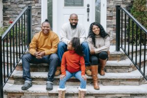 black family sitting on front steps